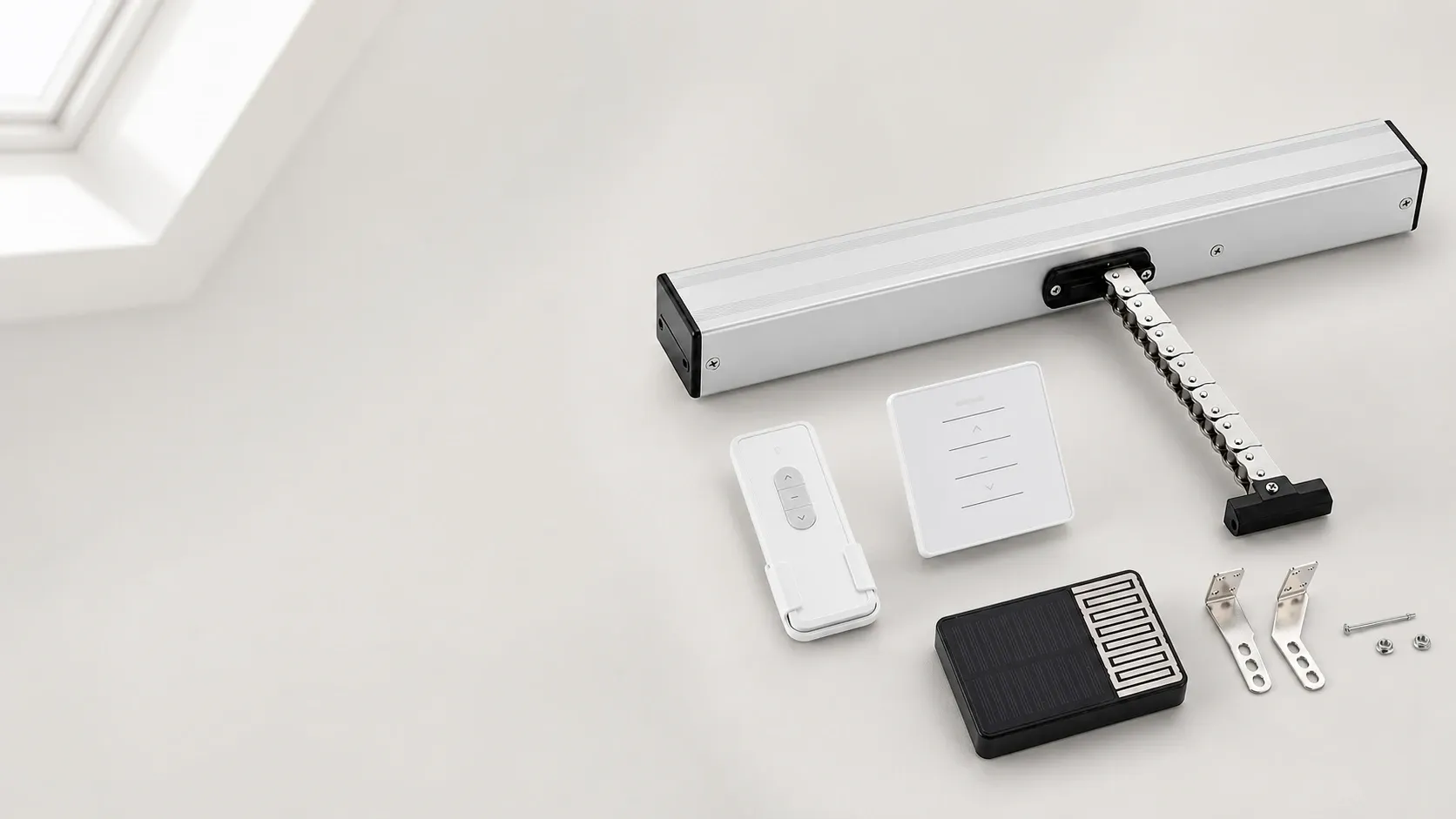 Product kit for an automated skylight and roof vent opener, showing a silver electric actuator, remote controls, solar or sensor unit, mounting brackets and hardware on a clean light background.
